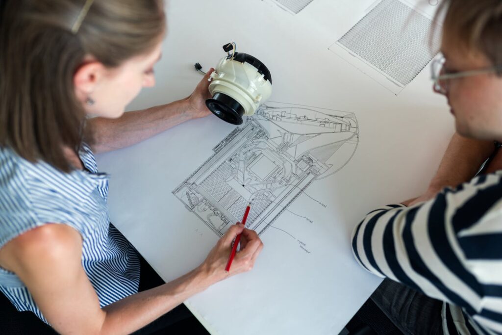 Engineers reviewing a technical drawing
